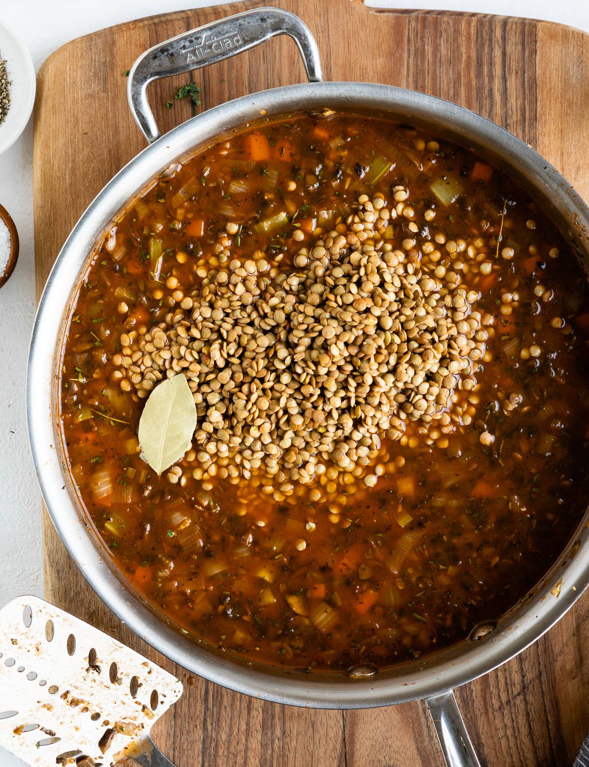 Lentils in a pot of vegetables and stock.