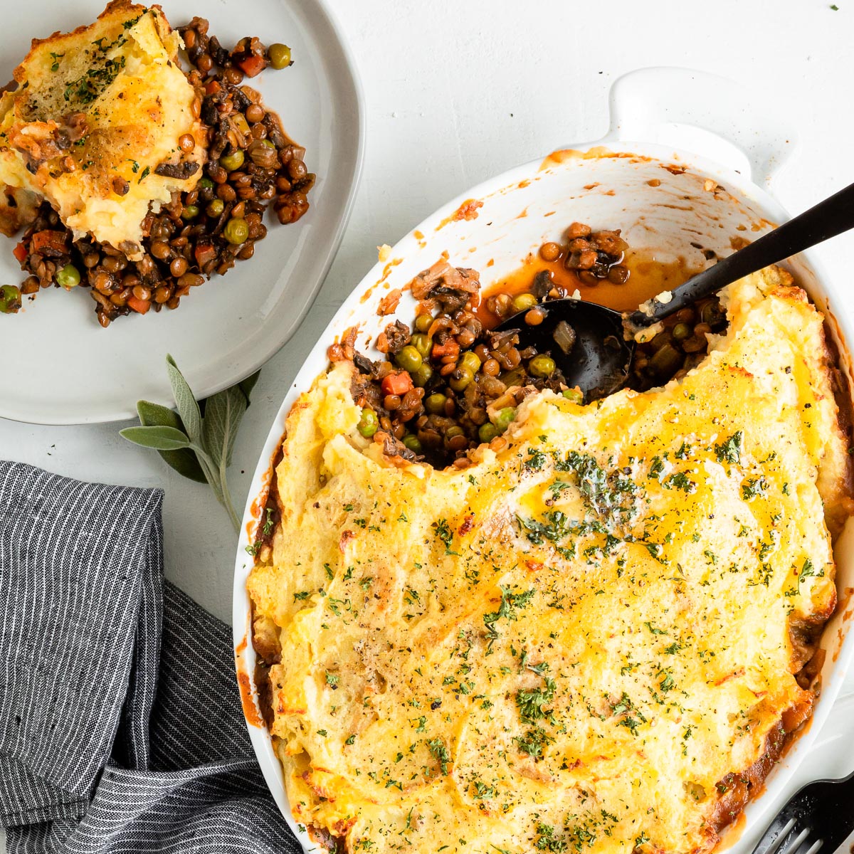 Serving spoon in a serving dish of vegetarian shepherd's pie.
