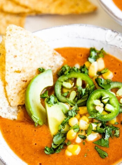 vegetarian tortilla soup topped with fresh ingredients.