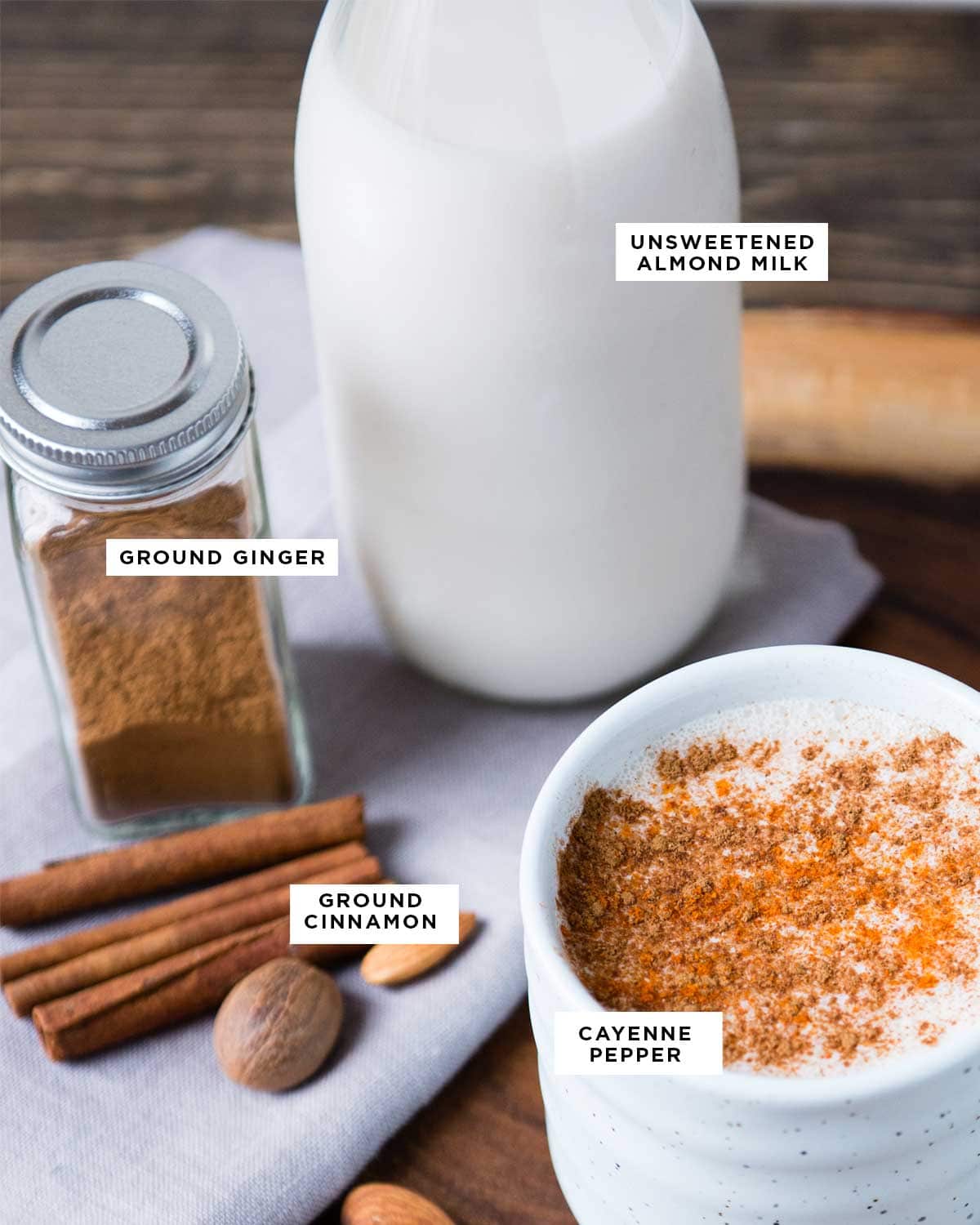 ingredients for warm milk before bed including almond milk, ground ginger, ground cinnamon and cayenne pepper