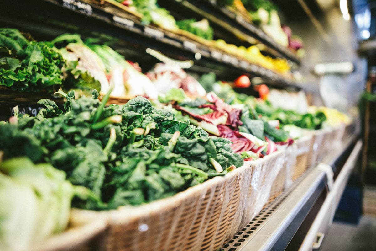 grocery produce isle full of leafy greens.