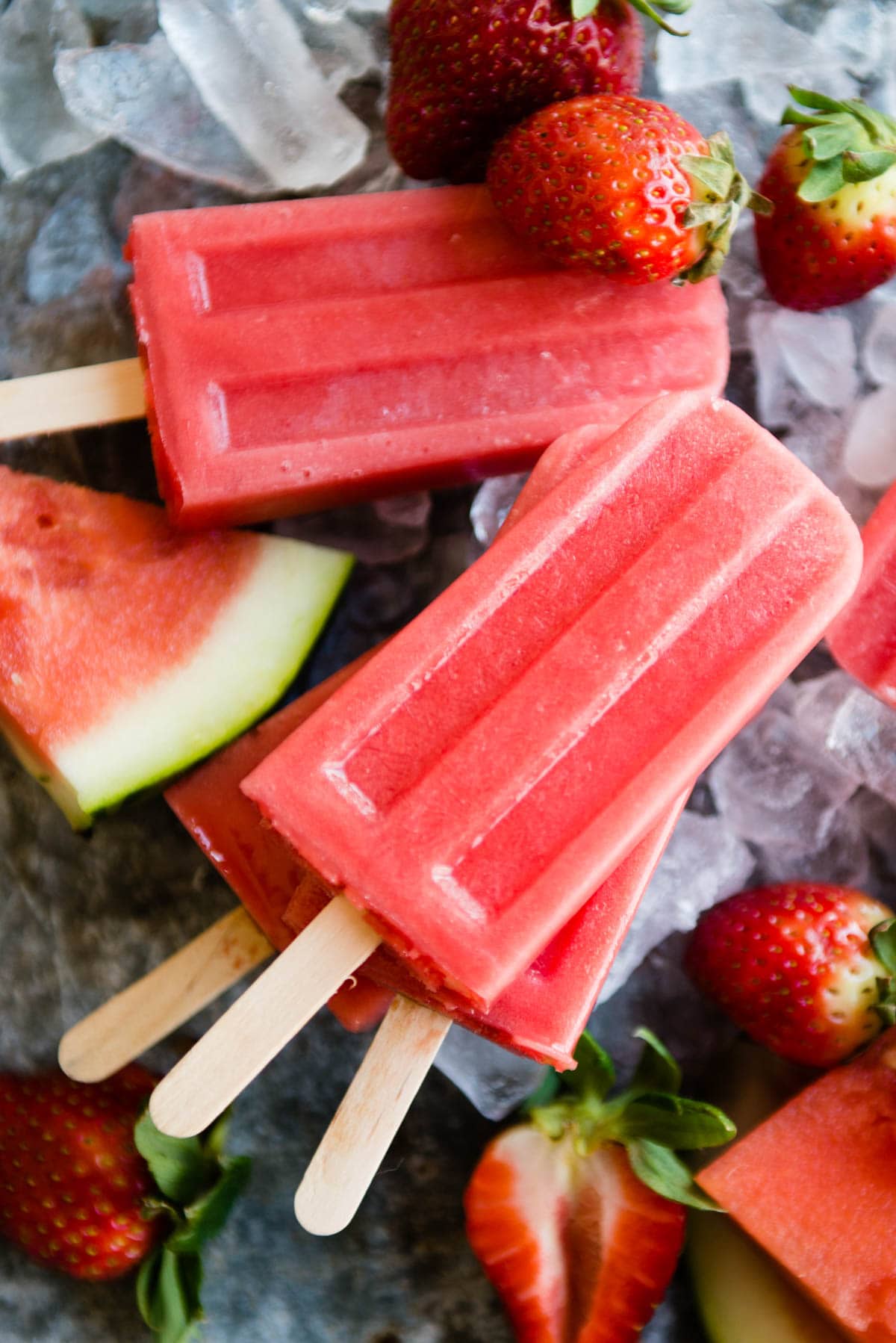 healthy fruit popsicles on wooden sticks.