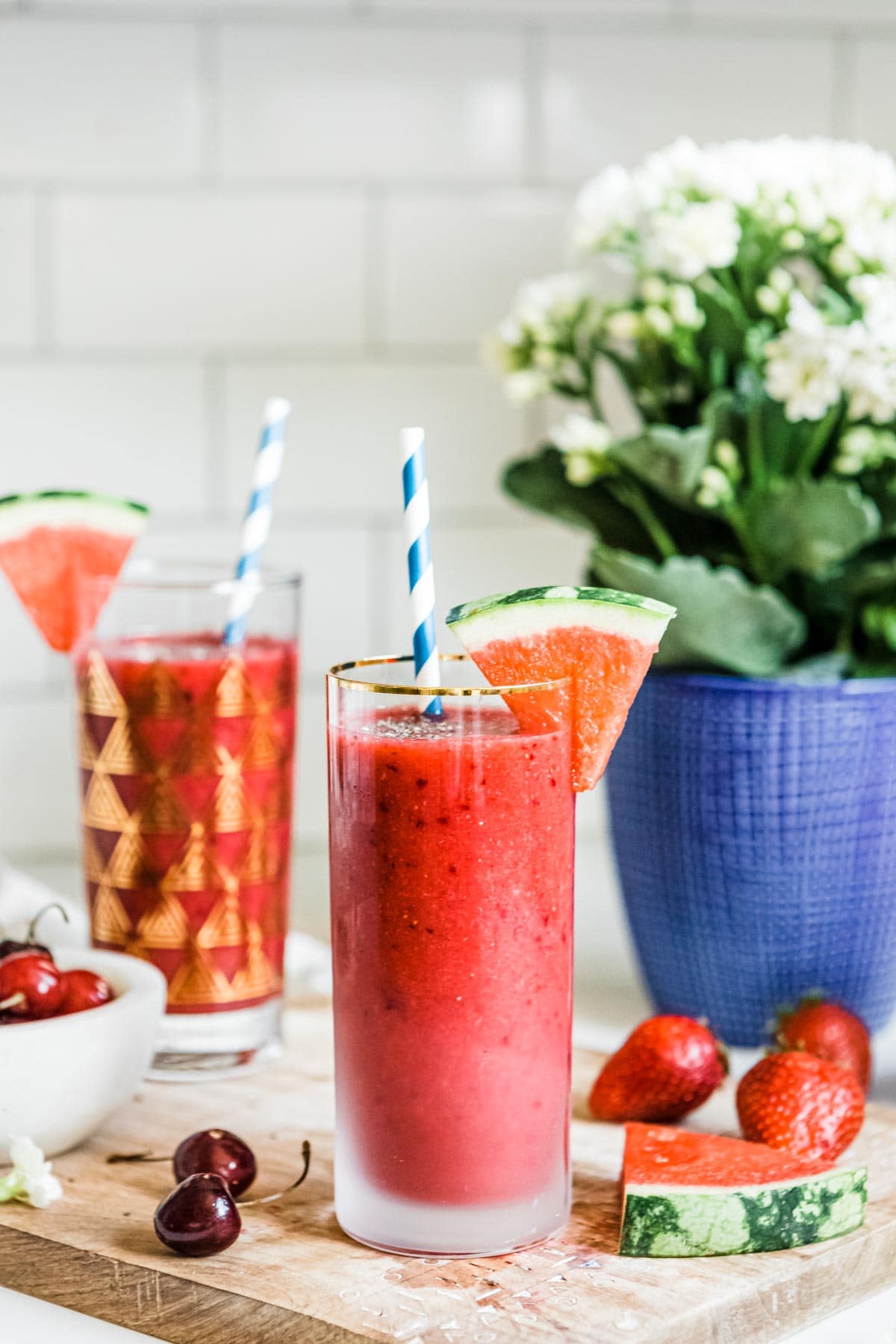 watermelon smoothie gold rimmed glass with paper straw and watermelon wedge