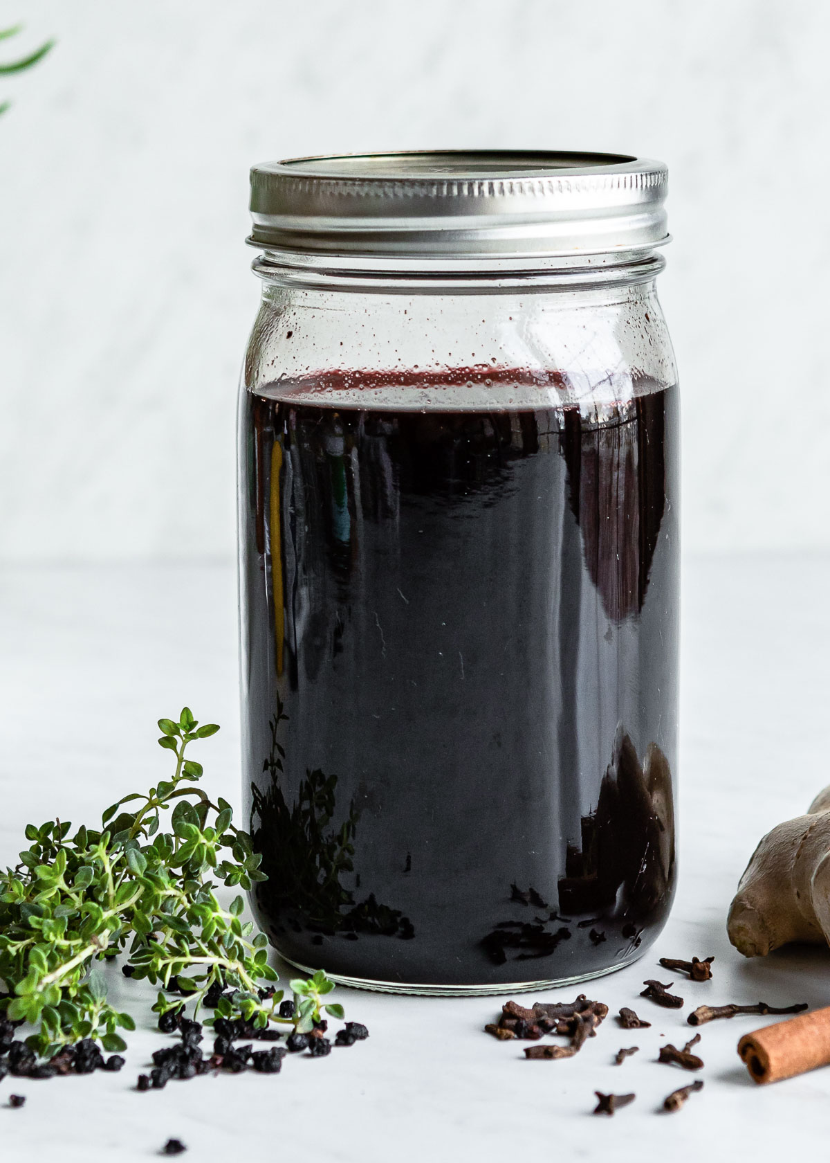 Homemade elderberry syrup in a Mason jar