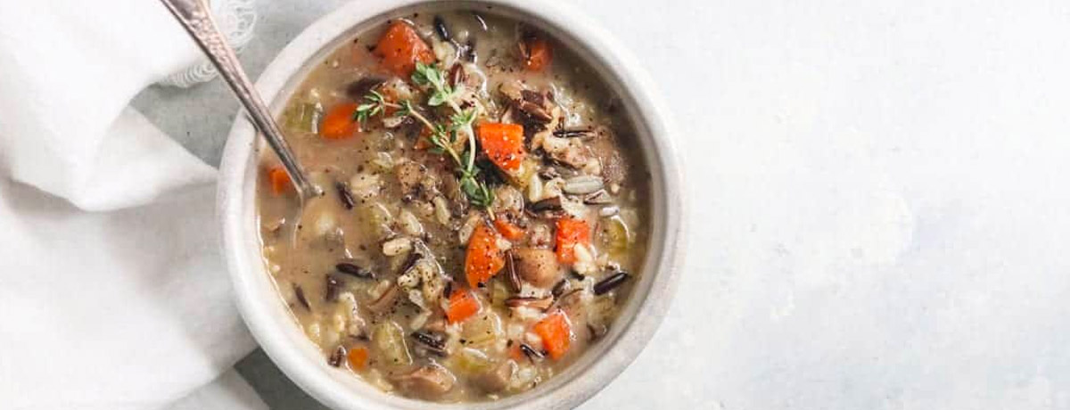 wild rice soup with mushrooms in a bowl with a white napkin