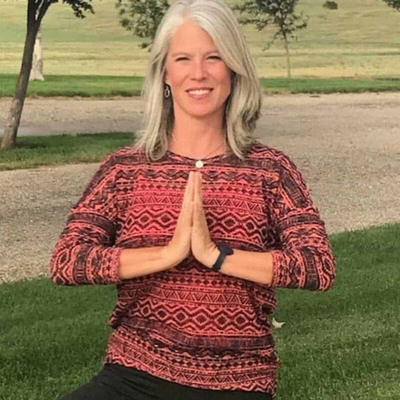 Woman in a red shirt doing yoga.