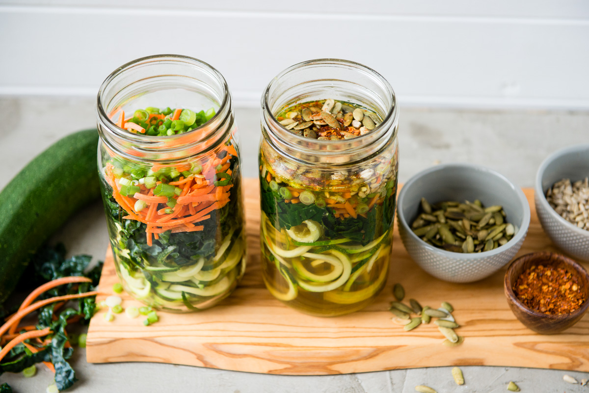 Mason jar with zoodles layered in it with carrots.